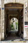 This open wooden door provides a peak into the apartment block